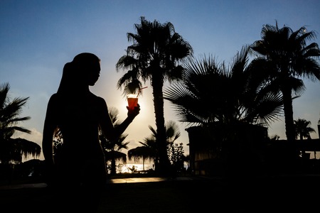 silhouette of a girl with cocktailの写真素材