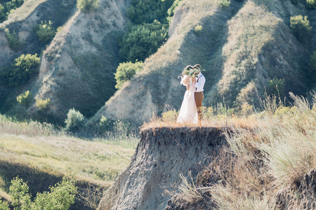 bride and groom hugging at the wedding in nature.の写真素材