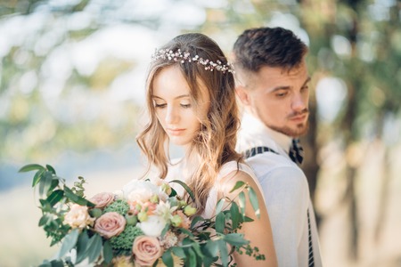 bride and groom hugging at the wedding in nature.の写真素材