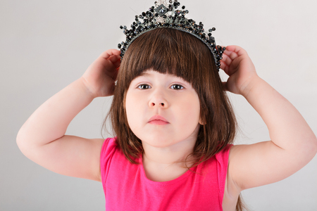 portrait of beautiful little girl in pink Princess dress with crの写真素材