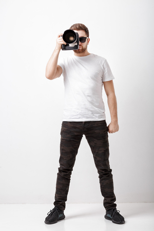 professional photographer in t-shirt use digital camera with lonの写真素材