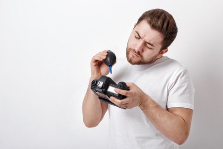 photographer cleaning camera with vacuum pump. hand blower dustの写真素材