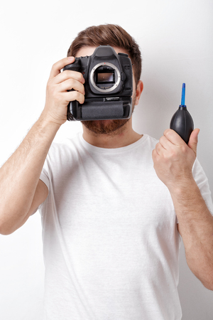 photographer cleaning camera with vacuum pump. hand blower dustの写真素材