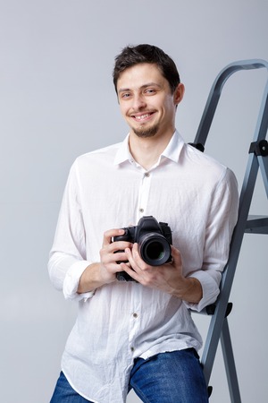 successful professional photographer use DSLR digital camera onの写真素材