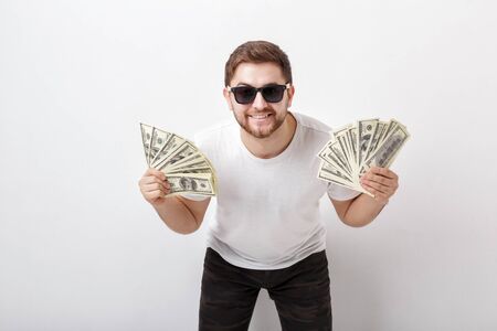 handsome smiling man with beard in shirt and sunglasses holdingの写真素材