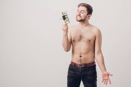 handsome smiling man with beard  holding a lot of hundred-dollarの写真素材