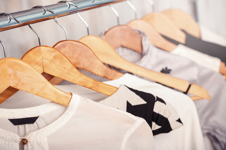 black and white womens clothes on hangers on rack in fashion stoの写真素材
