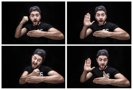 portrait of young attractive surprised brunette man in white shirt on gray background. surprising factの写真素材