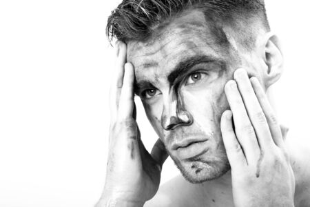 black and white portrait of a young man with streaks of paint on face . fantasy art of makeupの写真素材