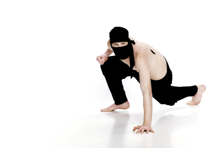 Ninja on white background. Male fighter in black clothesの写真素材