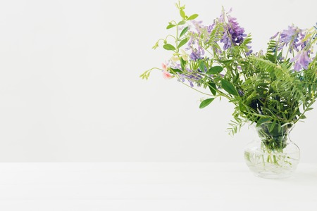 bouquet of pink  flowers in vase on white table. Empty space for textの写真素材