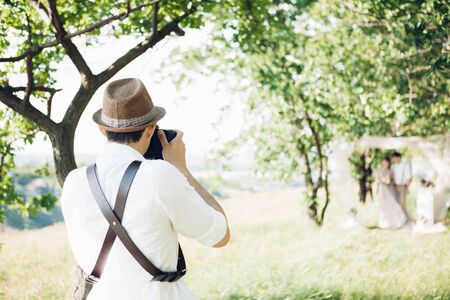 wedding photographer takes pictures of bride and groom in nature, fine art photoの写真素材