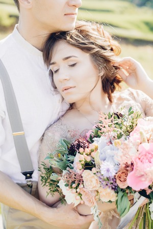 wedding couple on  nature.  bride and groom hugging at  wedding.の写真素材