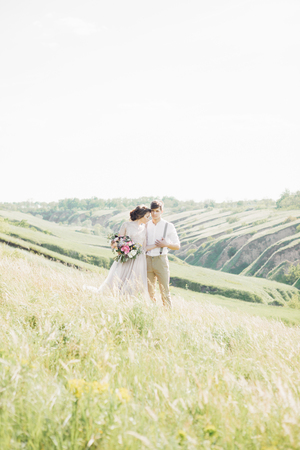 wedding couple on  nature.  bride and groom hugging at  wedding.の写真素材