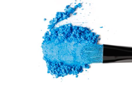 Broken blue eye shadow and brush isolated on white backgroundの写真素材