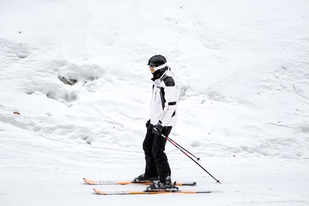 skier is skiing down the slope in the woodsの写真素材