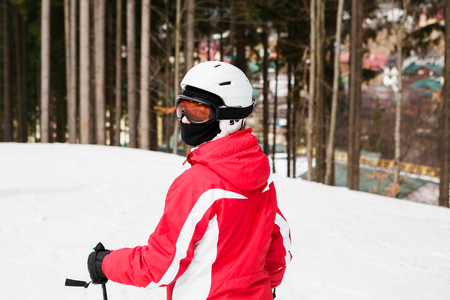 skier is skiing down the slope in the woodsの写真素材