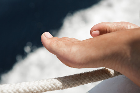 female legs against background of sea waterの写真素材