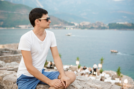 tourist looking at view of  old town in Budvaの写真素材