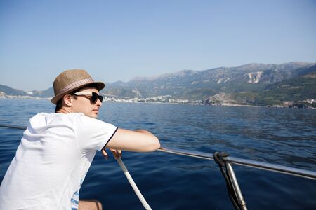 man aboard a boat looking at the sea