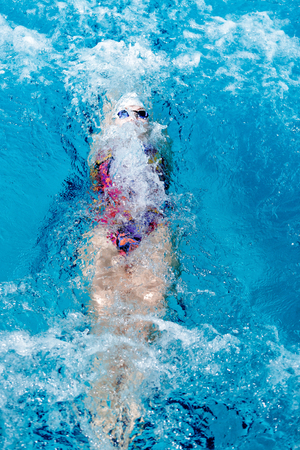 woman swimming with swimming hat in swimming poolの写真素材