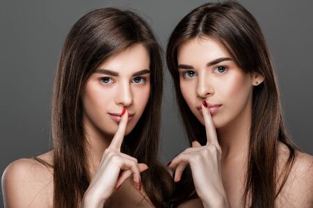 twins women with perfect skin and natural make-upの写真素材
