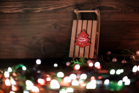 sled  and Christmas decor on the wooden background.の写真素材