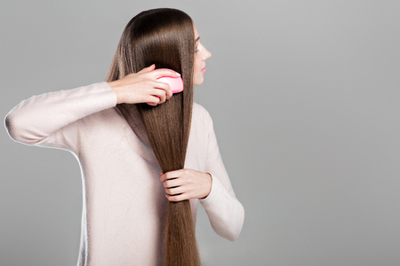 woman combing  long natural hairの写真素材