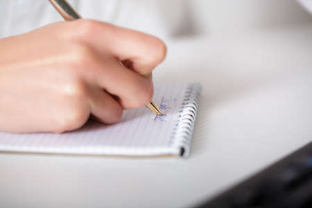 business woman hand writing on paper.