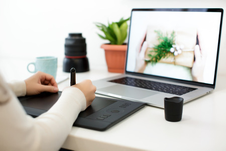 retouching on computer laptopの写真素材