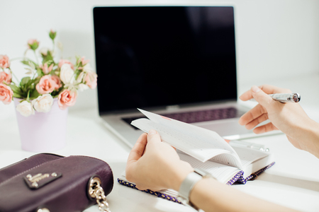 womans hand writing in empty notepadの写真素材