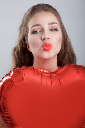 woman with heart shaped air balloons.の写真素材