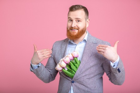 Handsome man holding bouquet of tulipsの写真素材