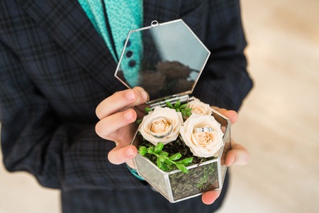 babys hands hold box with ringsの写真素材