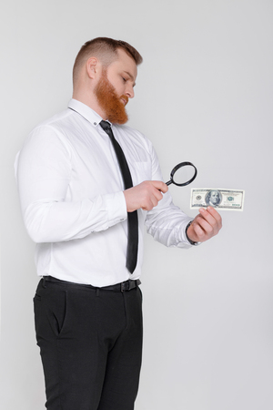 expert looking at magnifying glass for billの写真素材