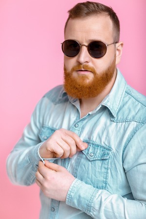beard man in sunglasses and denim shirtの写真素材