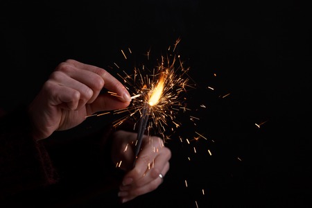 Female hands holding bengal light.の写真素材