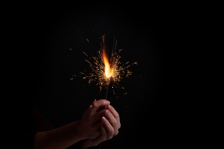 Female hands holding bengal light.の写真素材