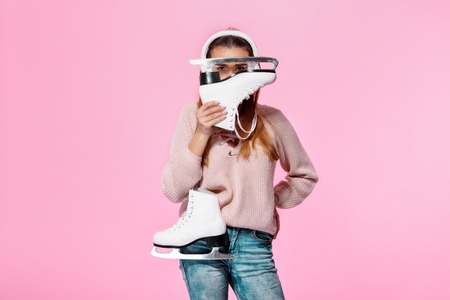 attractive woman holding ice skates
