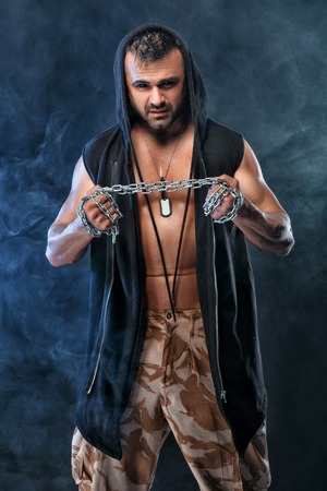 athletic handsome muscular man with chainの写真素材