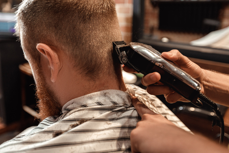Barber and bearded man in barber shopの写真素材