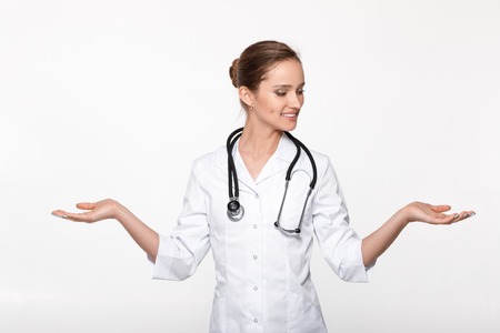doctor showing choice between two objectsの写真素材