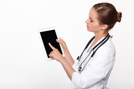 woman doctor showing screen digital tabletの写真素材