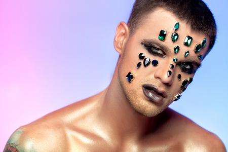 fantasy art makeup. man with rhinestones and jewelsの写真素材