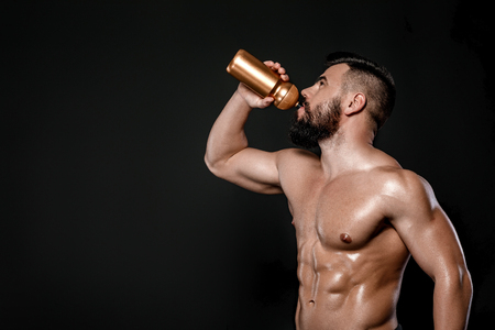 Handsome strong bodybuilder posing in studioの写真素材