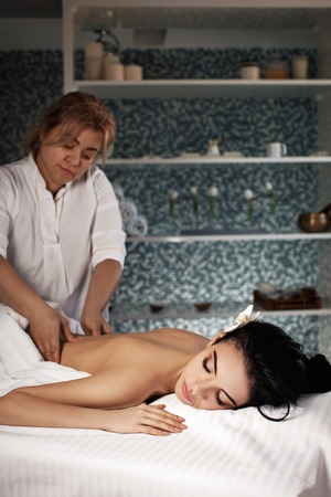 Relaxed woman receiving massageの写真素材