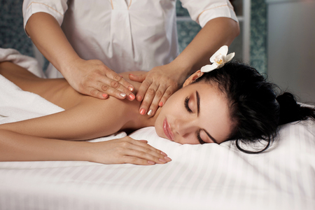Relaxed woman receiving massageの写真素材
