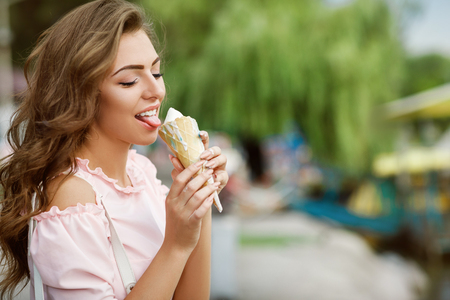 young smiling girl with ice creamの写真素材