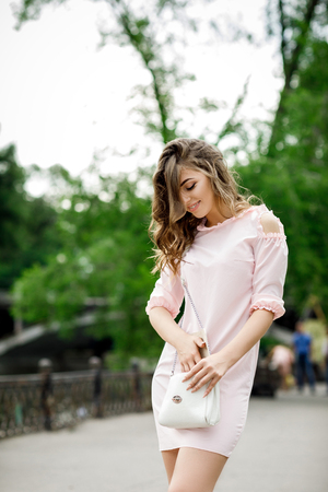 beautiful girl with handbag in parkの写真素材