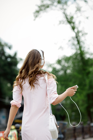 young woman listening to music on headphonesの写真素材